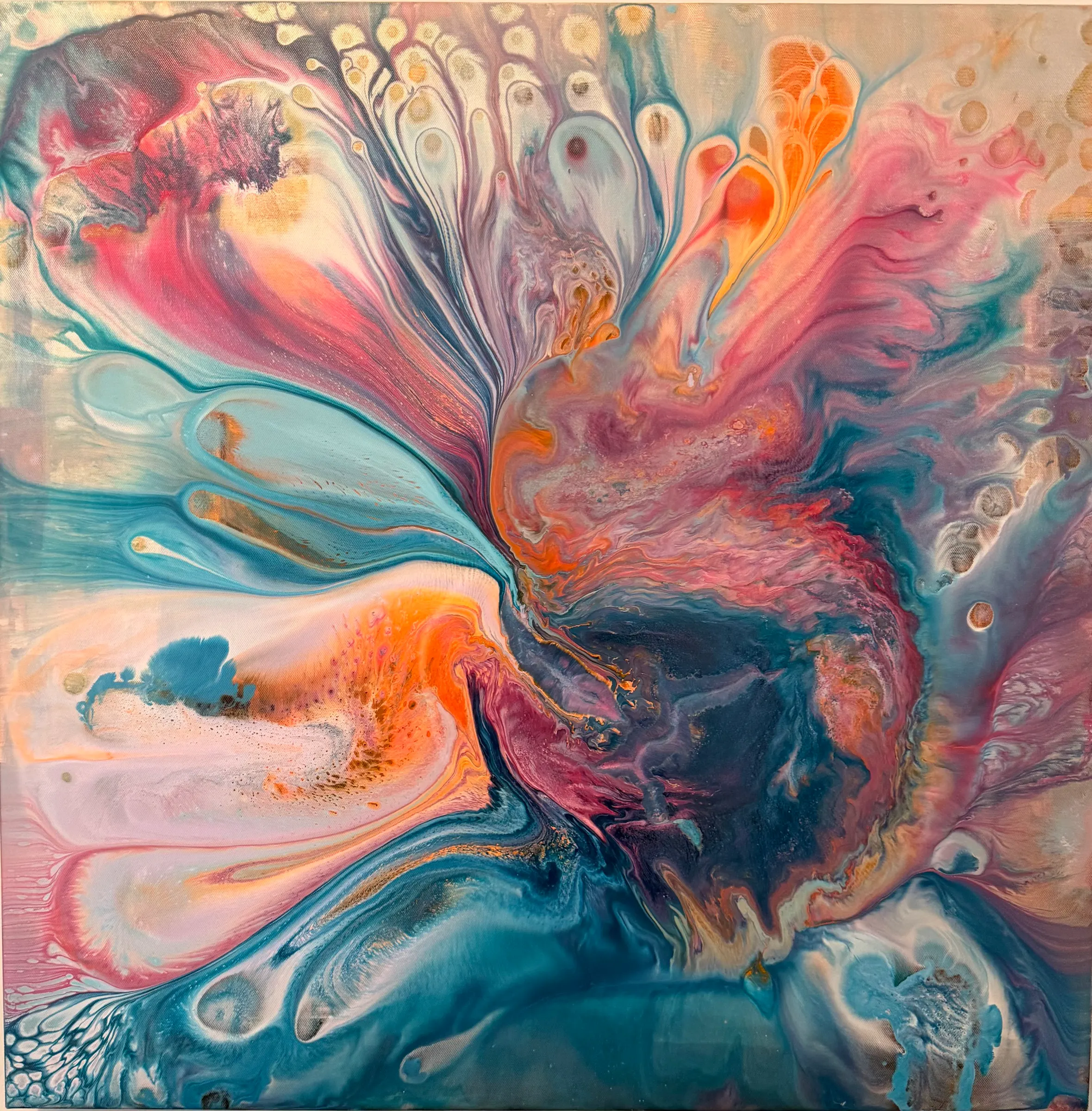 An abstract poured painting in which streams of coral, orange, pink, teal and cream fan upward from a dark center like petals.